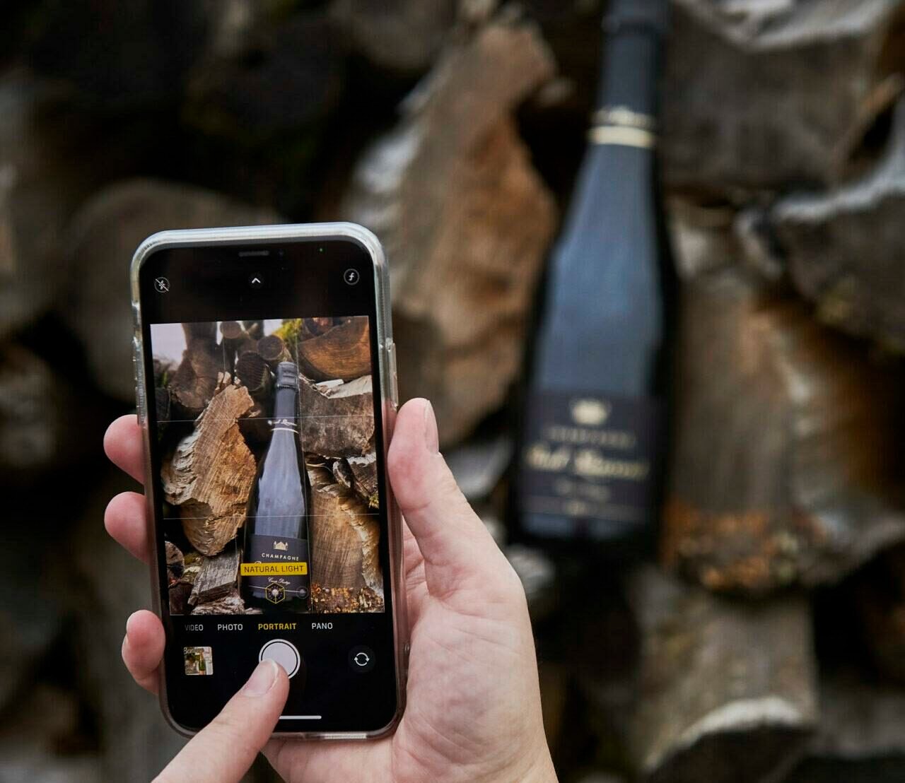 A bottle of Champagne Paul Laurent on stacked firewood